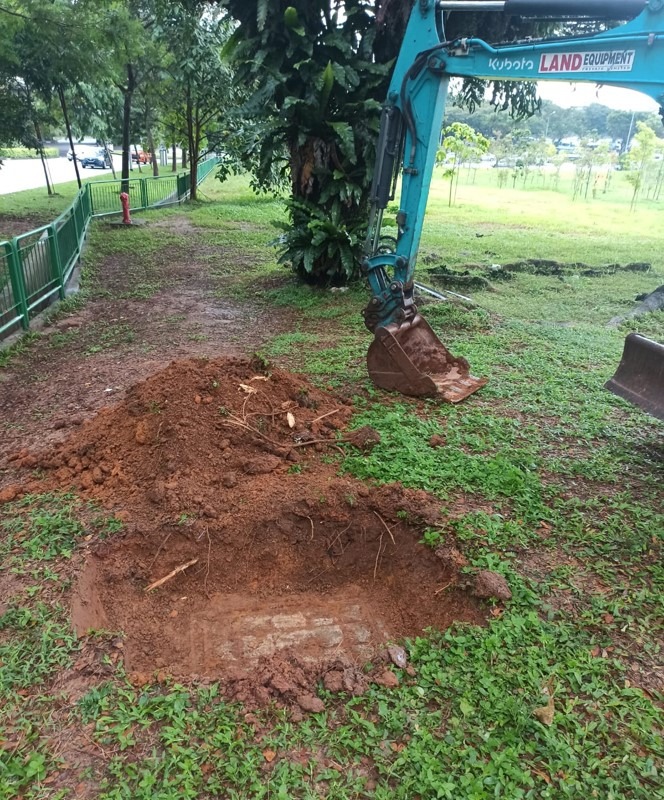 Trial pit exposing a buried telecom chamber